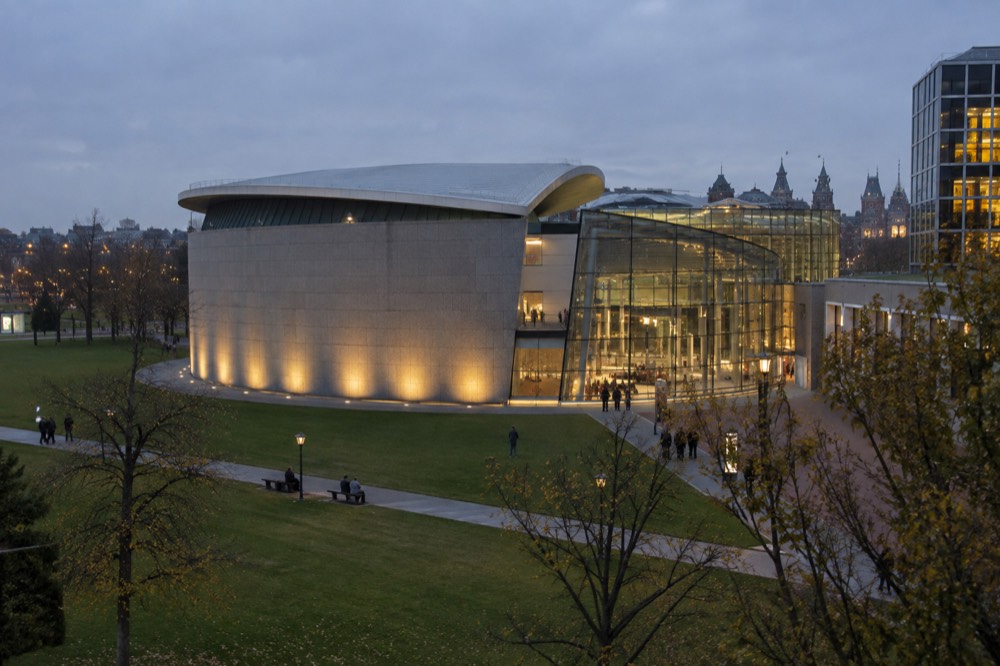 The illuminated facade of the Van Gogh Museum on Museumplein at dusk