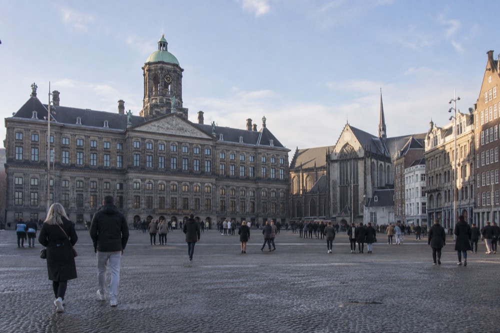 Brick facades and a quiet canal edge beside Dam Square