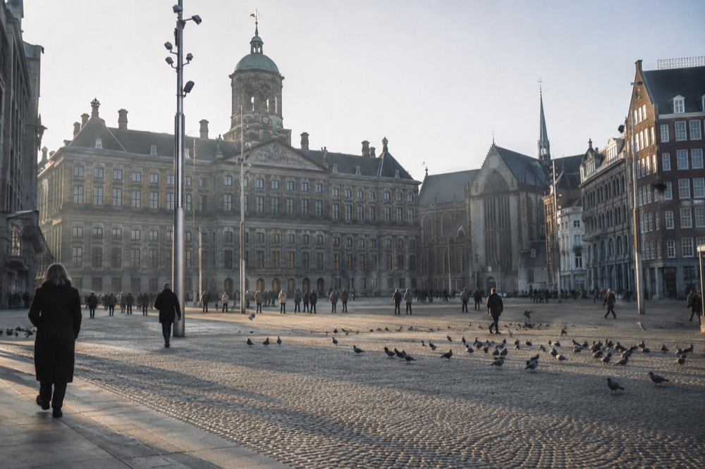 The waterfront near Dam Square under a broad grey northern sky