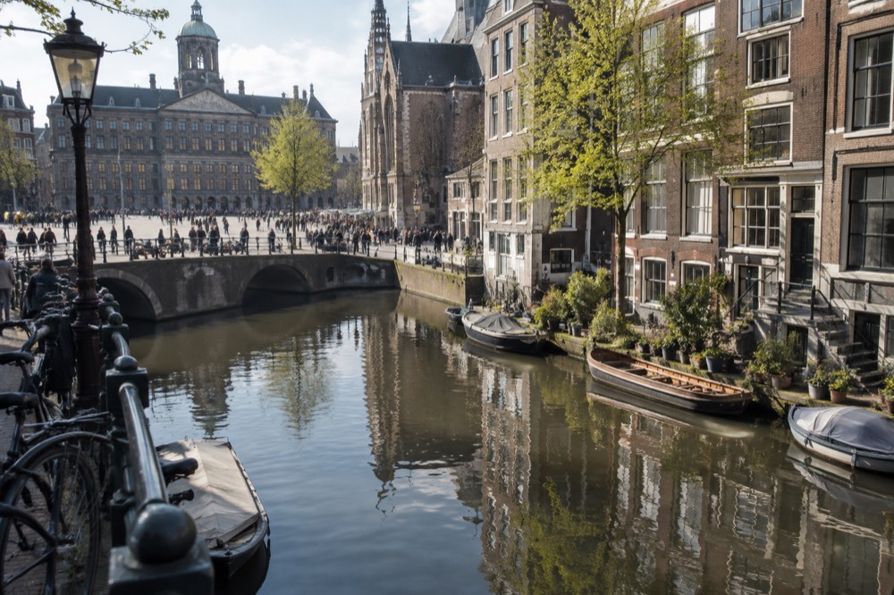 Seventeenth-century canal houses reflected in the water of an Amsterdam gracht