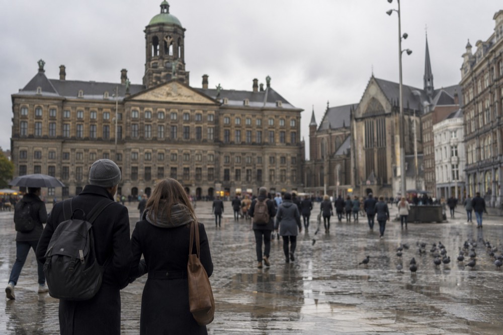 A quiet corner of Dam Square with trees overhanging the water