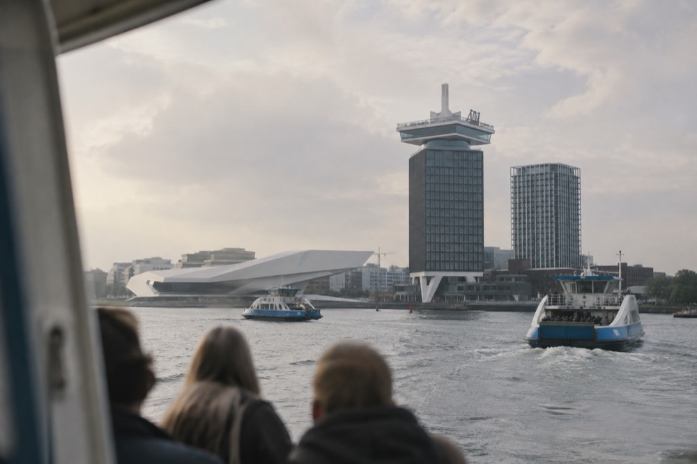 A'DAM Tower seen from the IJ river with ferries crossing in the foreground