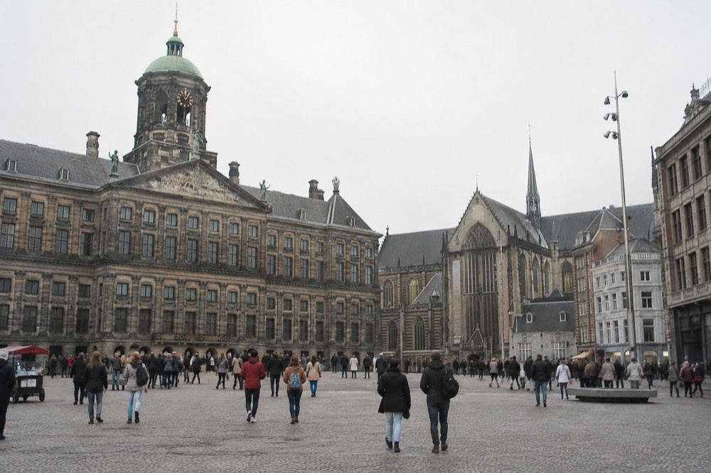 The waterfront near Dam Square under a broad grey northern sky