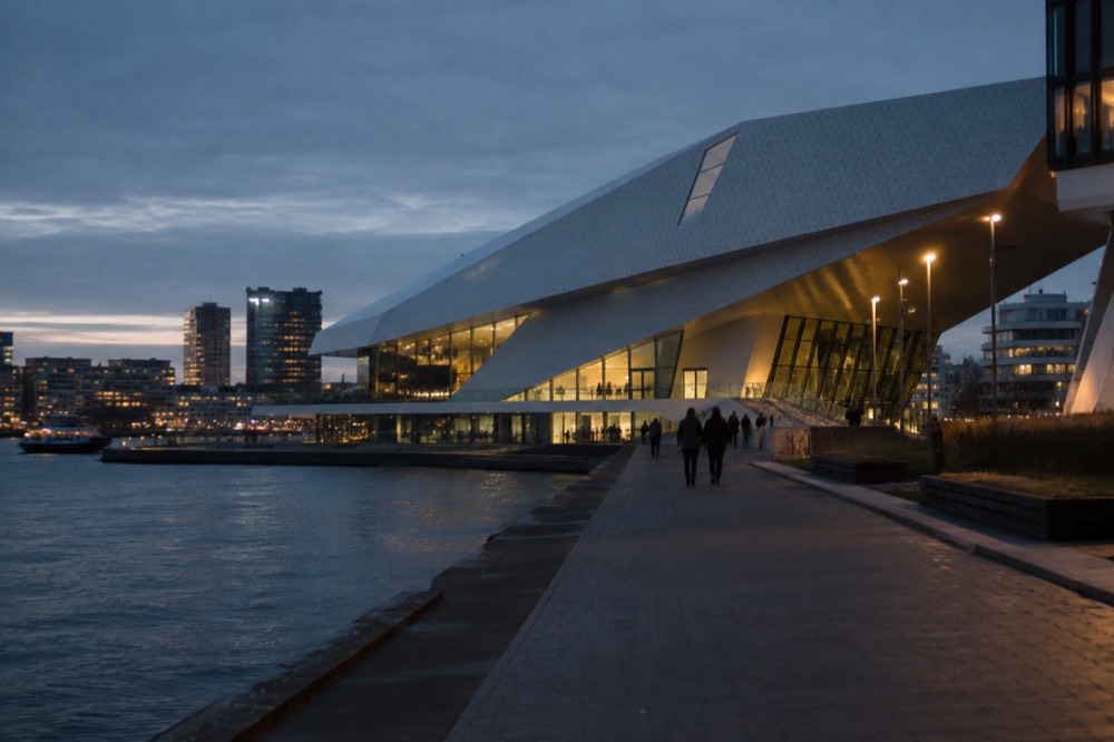 People walking past Eye Filmmuseum, seen from across the street