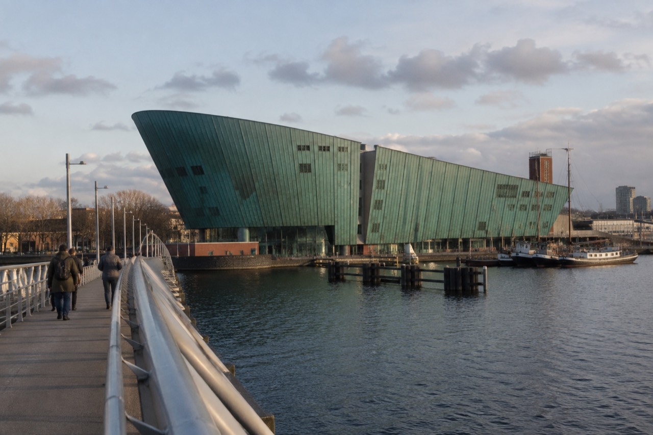 The distinctive green copper-clad NEMO Science Museum building shaped like a ship rising above Amsterdam's Oosterdok waterfront