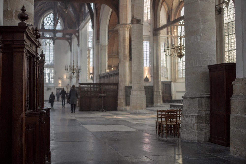 A quiet corner of Oude Kerk with trees overhanging the water