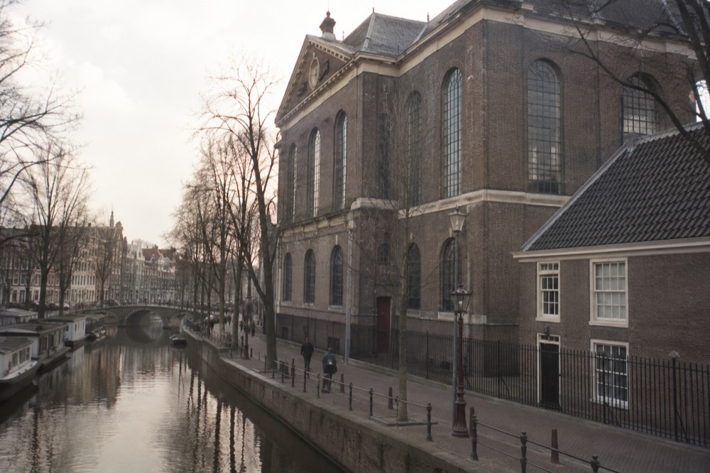 A canal bridge and moored boats close to Portuguese Synagogue