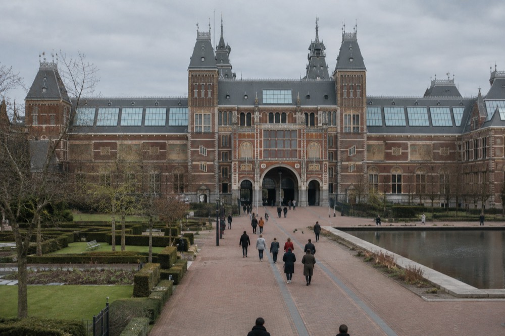The frontage of Rijksmuseum viewed from the opposite bank