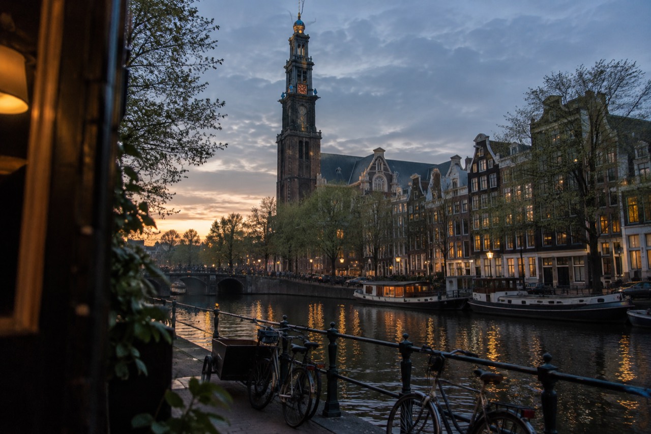 The Westerkerk tower rising above the gabled houses along the Prinsengracht canal