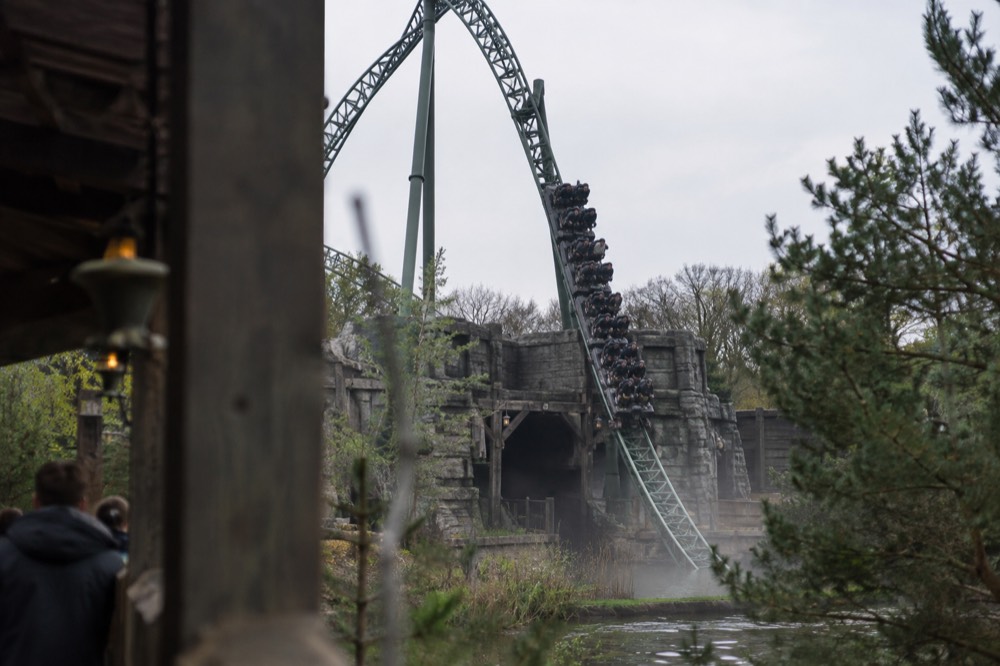 Efteling dive coaster track with a train plummeting into the mineshaft