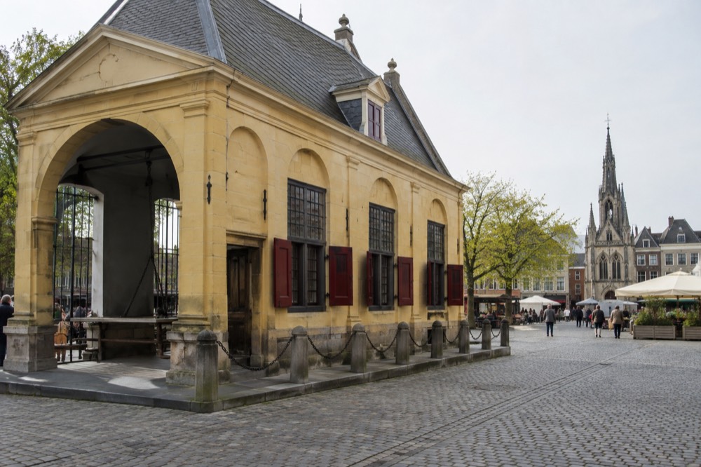 The yellow cheese market weigh house beside the market square in Gouda on a bright morning