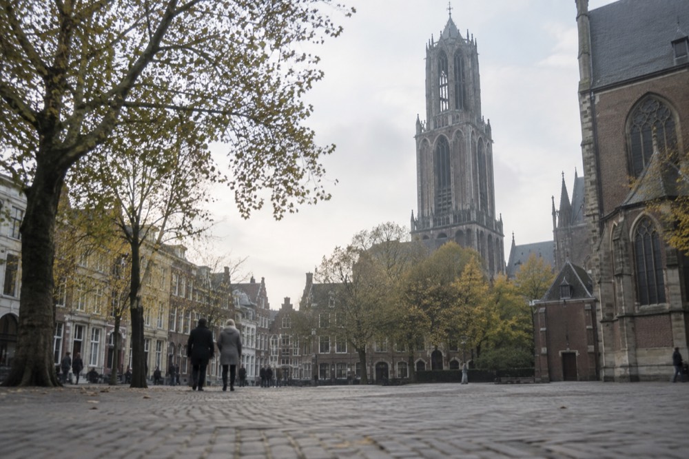 The Domplein square in Utrecht with the Gothic Dom Tower rising above the rooftops
