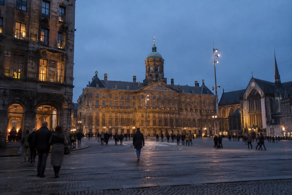 People walking past Dam Square, seen from across the street