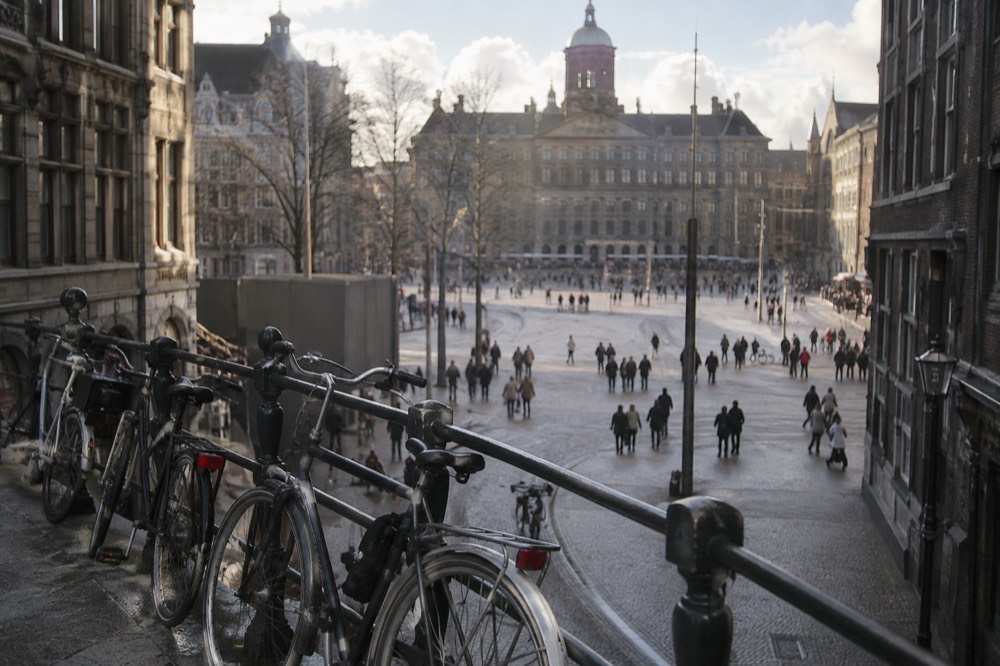 The approach to Dam Square, with bicycles leaning against the railings