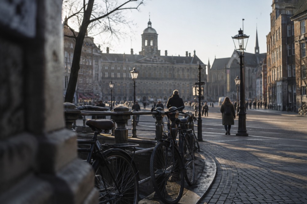 The approach to Dam Square, with bicycles leaning against the railings