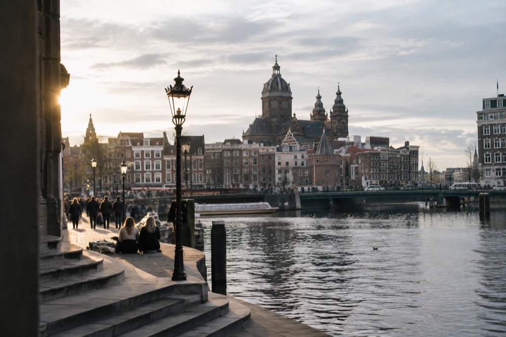 The waterfront near Dam Square under a broad grey northern sky