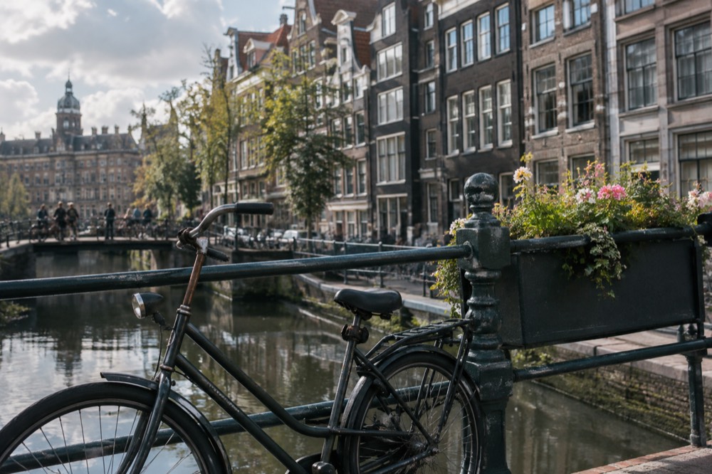 Brick facades and a quiet canal edge beside Dam Square
