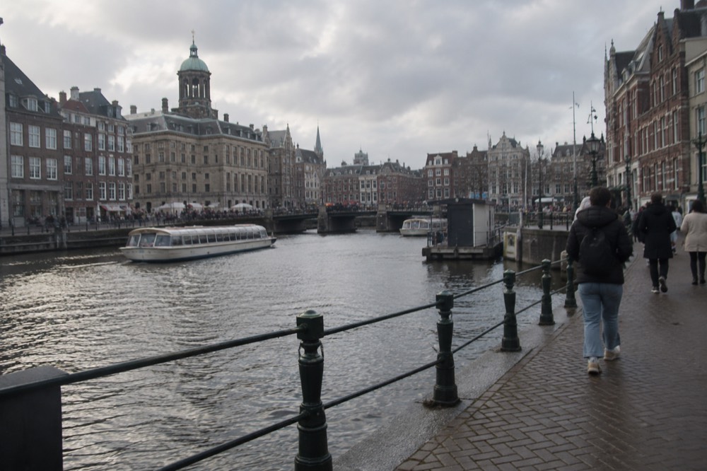 The waterfront near Dam Square under a broad grey northern sky