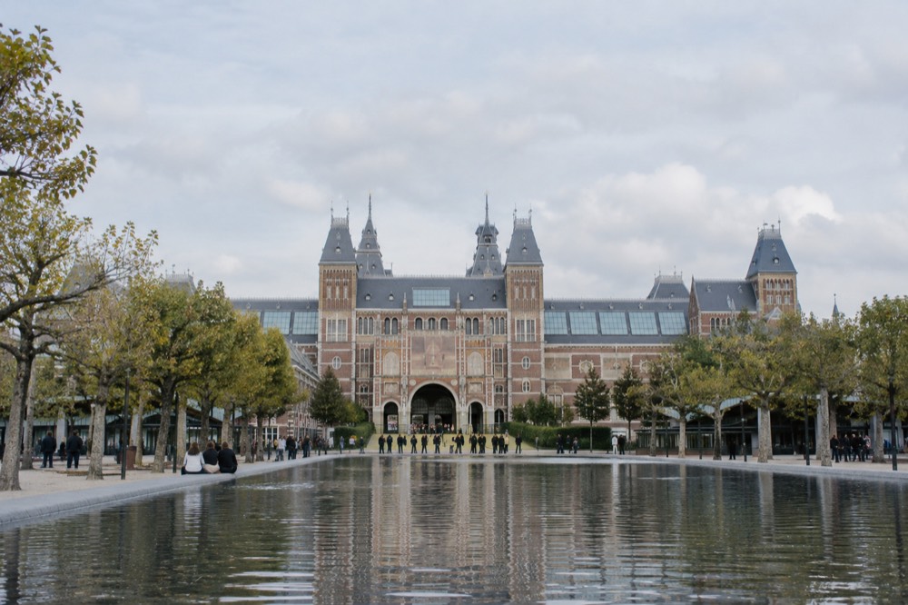 The Museumplein pool with the Rijksmuseum facade behind it on a bright day